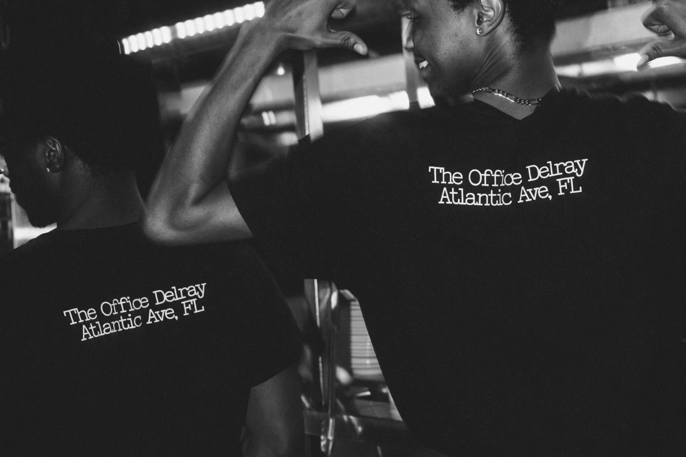 The Office Delray floor team, in shirts reading The Office Delray, Atlantic Ave, FL